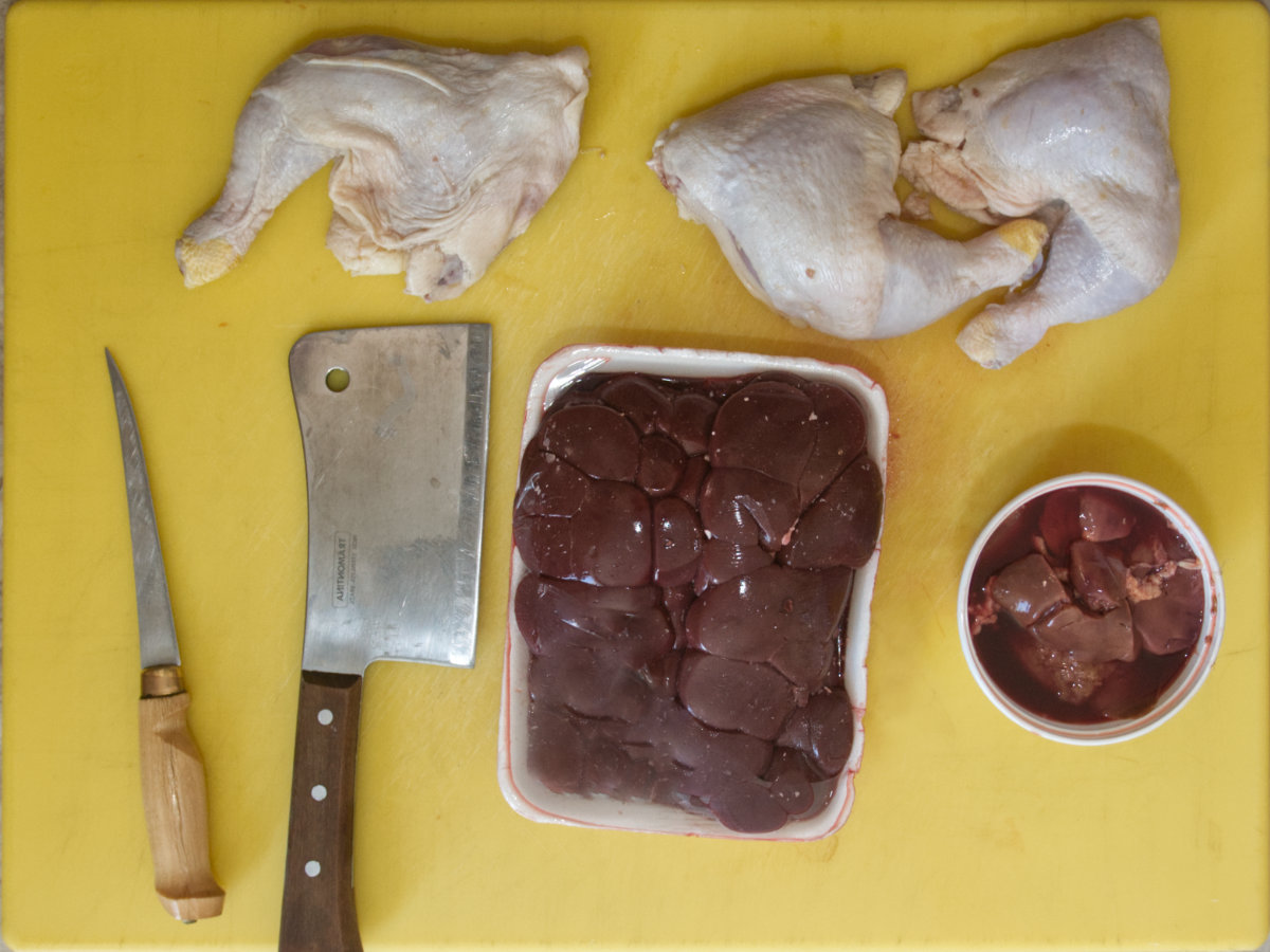 This homemade raw cat food recipe includes chicken thighs with bones and skin, liver, and beef kidney