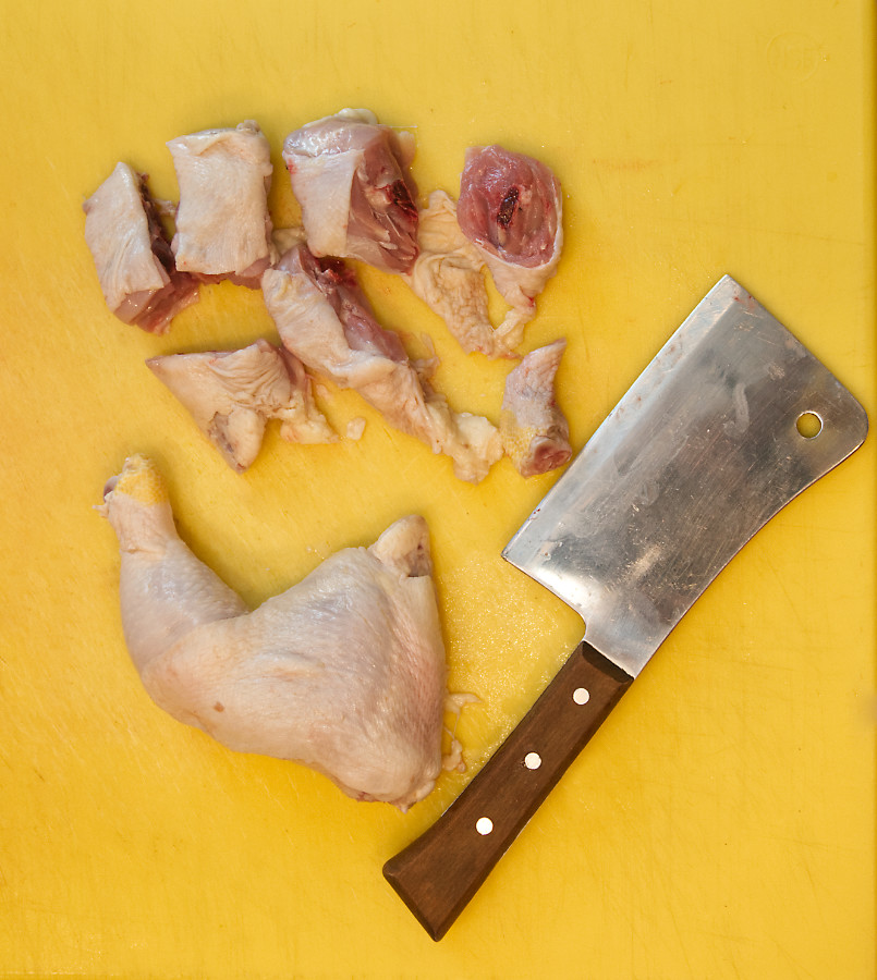 Chicken leg quarters cut into pieces for meat grinder